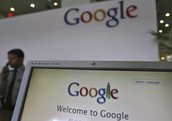 A security personnel answers a call at the reception counter of the Google office in Hyderabad.