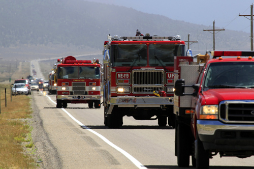 A line of fire trucks make their way down US highway 89 toward the Wood Hollow Fire north of  Fairview, Utah.
