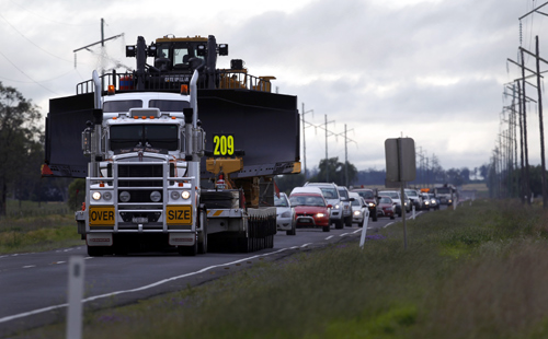 Highway traffic is backed up behind a piece of heavy mining equipment as it rolls though Dalby, 180 km (112 miles) west of Brisbane.