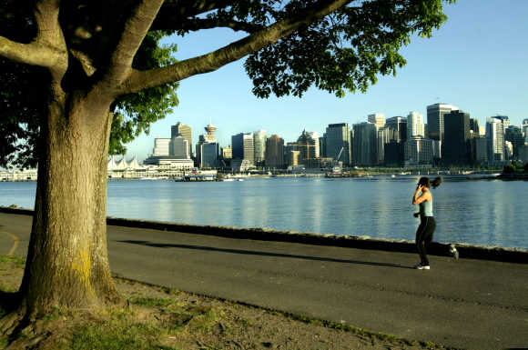 A jogger runs along the seawall in Stanley Park in Vancouver.