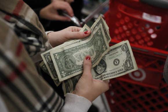 A customer counts her money in Torrington, Connecticut, United States.