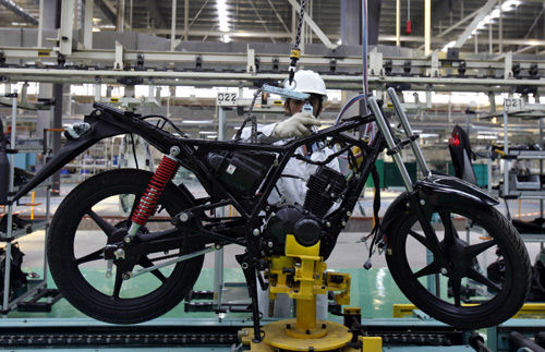 An employee works at an assembly line of Twister motorcycle at the newly inaugurated plant of Honda Motorcycle and Scooter India (HMSI) Pte in Tapukara in Rajasthan.