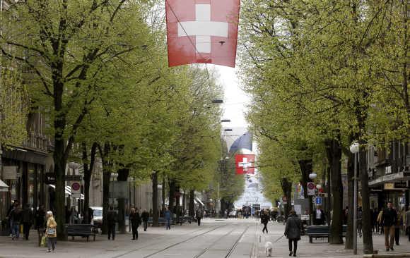 People walk on Zurich's main shopping street Bahnhofstrasse.