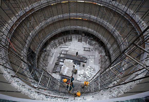 Construction workers erect scaffolding at the site of a commercial building in Mumbai.