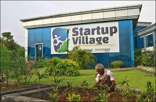 A gardener plants seedlings at the entrance of Start-up Village in Kinfra High Tech Park in Kochi.