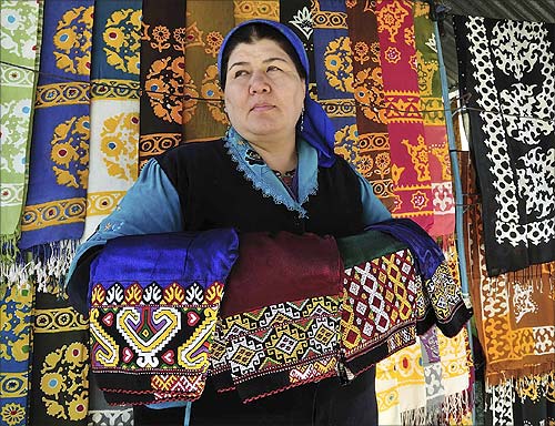 A woman looks out from her stall selling traditional garments and textiles at a market in the Turkmen capital Ashgabat.