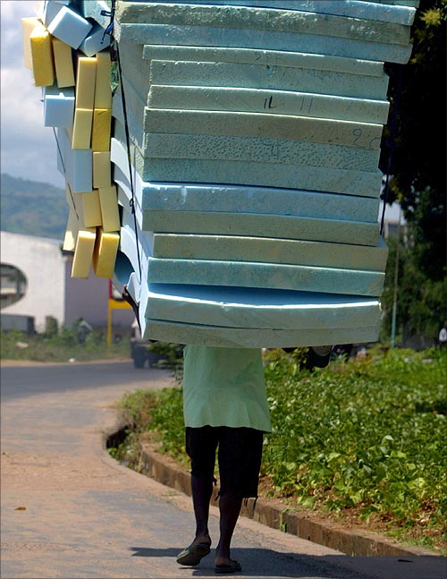 A Burundian villager carries a hip of mattresses for sell in the streets of capital Bujumbura.