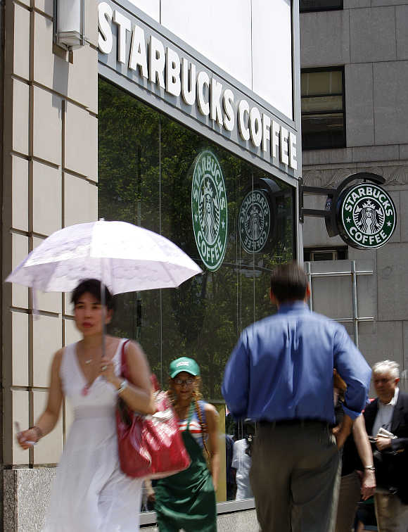 People walk past a Starbucks store in New York.