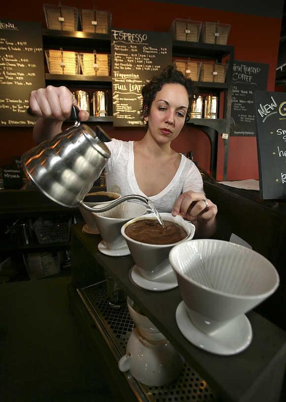 Vanessa Ament makes a cup of coffee at Starbucks in Seattle, Washington.