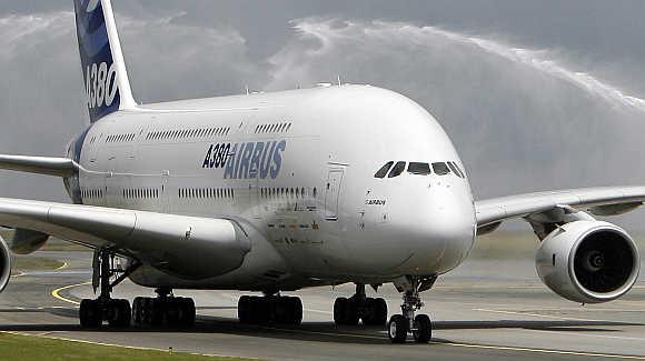 An Airbus A380 jet passes under the welcoming spray of firemen's hoses as it taxies on the runway after landing at Charles de Gaulle airport in Paris.