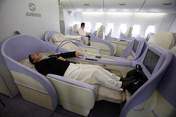 A woman checks out a First-Class seat of the Airbus A380 superjumbo in Shanghai.