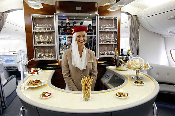 Flight attendant poses at bar in Business-Class section of Emirates' Airbus A380 in New York.