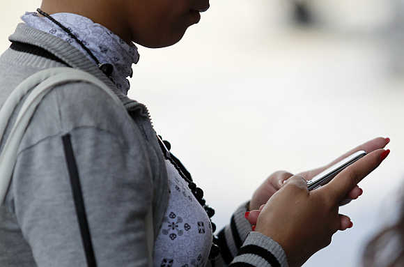 A woman uses her mobile phone in Caracas, Venezuela.