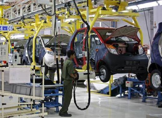 An employee works inside the plant for the Tata Nano car