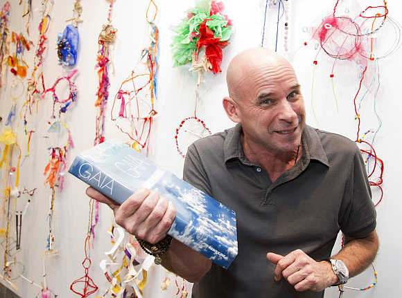 Cirque du Soleil founder Guy Laliberte with his book Gaia in Montreal, Canada.