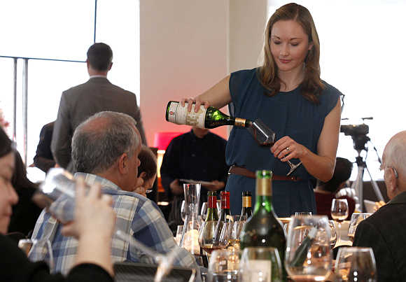 Carlee Donohue pours samples of rare wine at an auction in New York.
