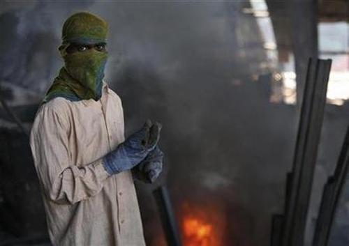 A labourer works inside a steel factory on the outskirts of Jammu.