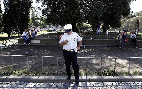 A traffic policeman uses his smartphone in Rome.