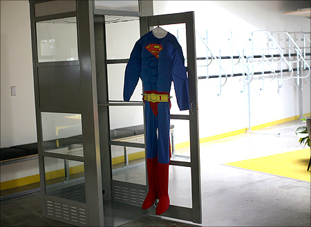 A superman costume hangs at a telephone booth for private cell phone discussions at the new headquarters of Facebook in Menlo Park, California.