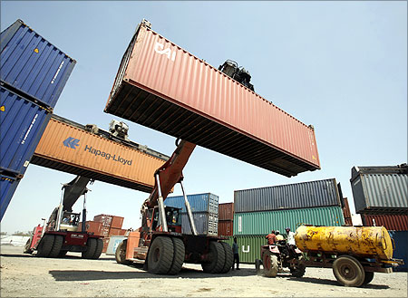 Mobile cranes prepare to stack containers at Thar Dry Port in Sanand.