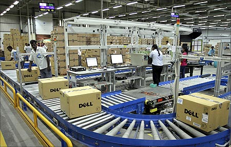 Computers packed into boxes are transported on a conveyor belt at a Dell factory in Sriperumbudur.