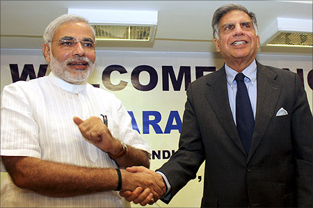 Chairman of Tata group Ratan Tata (R) shakes hands with Gujarat's Chief Minister Narendra Modi.