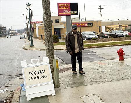 A man walks down Villard Avenue, a once active area dominated by factories that now have mostly closed in the 1st district where unemployment numbers are high.