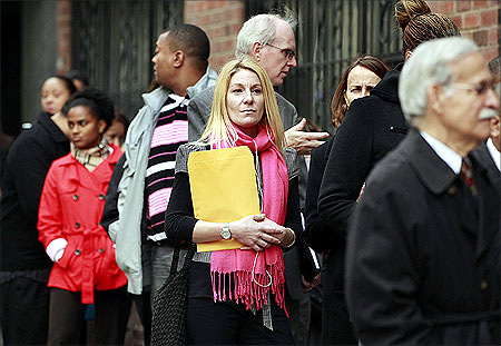 People wait in line to enter a job fair in New York.