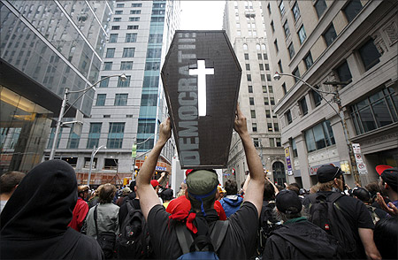 A protester carries an imitation casket marked