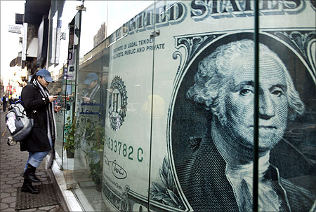 An Egyptian woman walks into a currency exchange office in downtown Cairo.