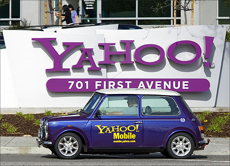 A man drives a Mini Cooper with a Yahoo! logo in front of Yahoo! headquarters in Sunnyvale, California.
