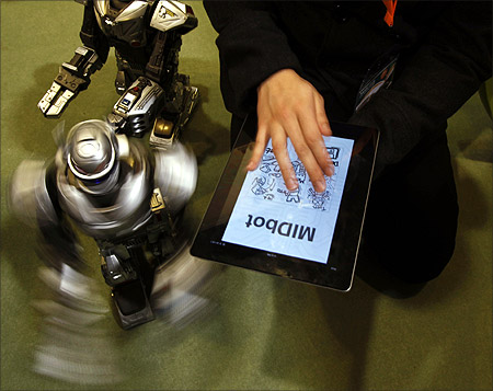 A robot moves while being controlled by a tablet computer app via bluetooth during the Hong Kong Toys and Games Fair.