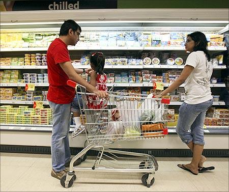 People shop in the chilled foods section of a Reliance Fresh supermarket in Mumbai.