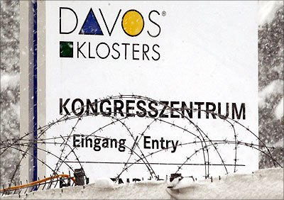 A fence and barbed wire are placed in front of a sign of the entrance of the congress center where the World Economic Forum held in the Swiss mountain resort of Davos