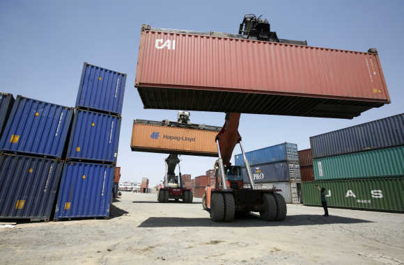 Mobile cranes prepare to stack containers at Thar Dry Port in Sanand in Gujarat.