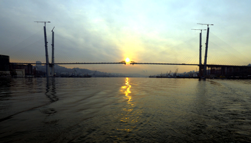 A bridge over the Golden Horn Bay is seen under construction during sunrise in the far eastern port of Vladivostok.