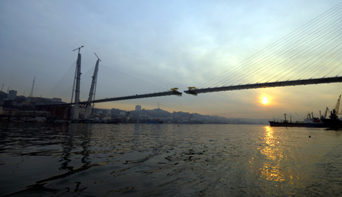 A bridge over the Golden Horn Bay is seen under construction during sunrise in the far eastern port of Vladivostok.