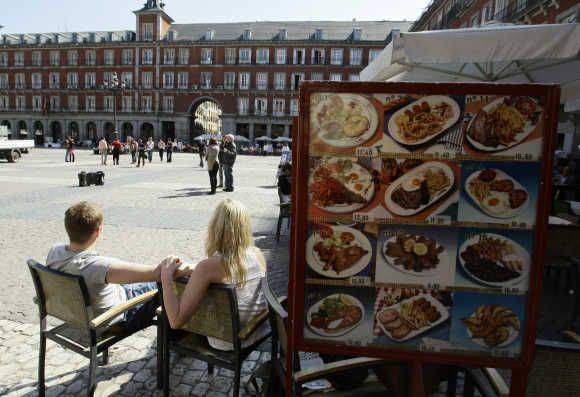 People sit in a restaurant in Madrid's central Plaza Mayor.