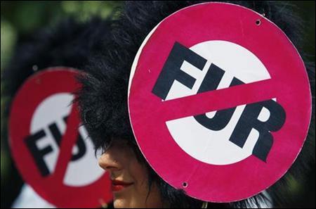 Two members of People for Ethical Treatment of Animals (PETA) protest against the use of bear skin in Sofia.