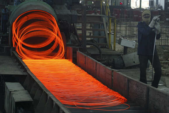 Labourer works inside a steel factory in Kanpur.