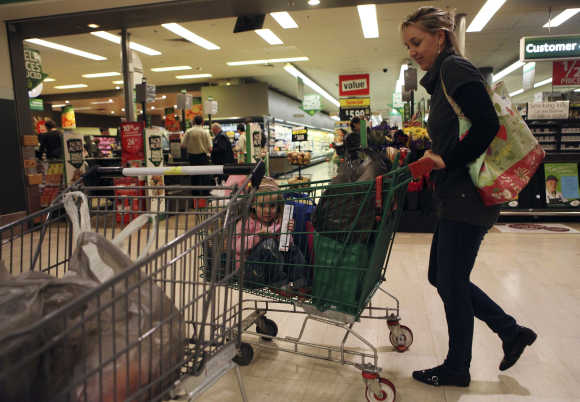 A customer leaves a Woolworths supermarket in Sydney.