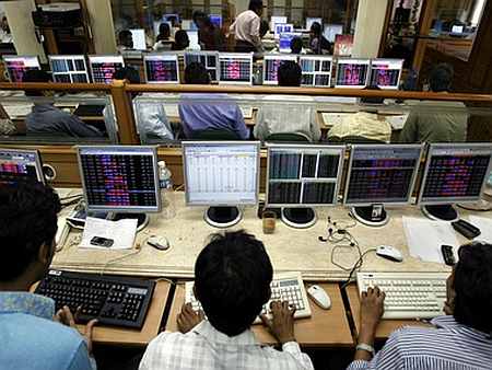 Indian brokers engage in trading on their computer terminals at a stock brokerage firm in Mumbai.