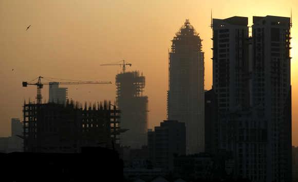 Buildings under construction are seen under the Mumbai skyline.