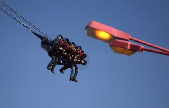 People enjoy a ride at Prater amusement park in Vienna.