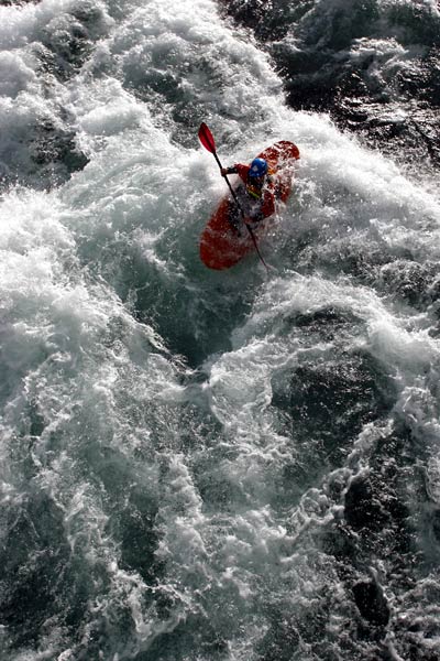 A tourist paddles his kayak on the Veagavatn river near Otta.