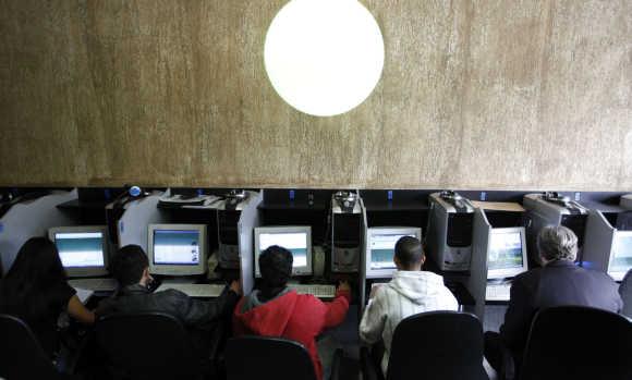 Customers use computers at an Internet cafe in Sao Paulo.