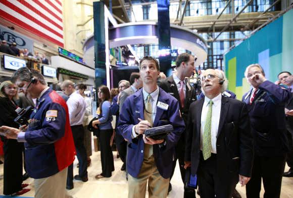 Traders work on the floor of the New York Stock Exchange.