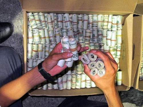 Dollars in cash are seen in this photograph released by Mexico's tax office in Mexico City.
