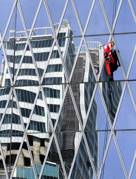 French climber Alain Robert, a rock climber who has become famous for climbing known buildings worldwide, climbs the 215m (705 feet) high, 50 floors BakrieTower building in Jakarta.