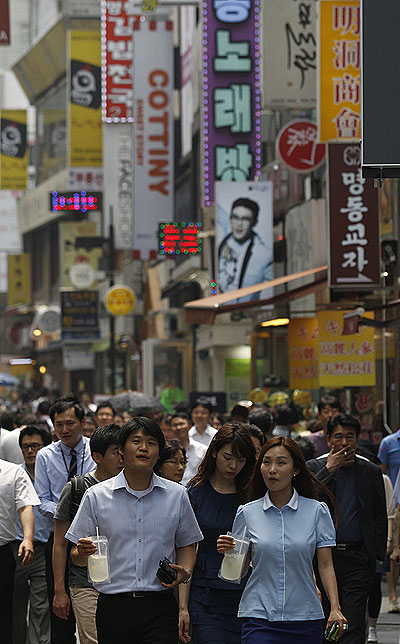 People walk at a shopping district in central Seoul.